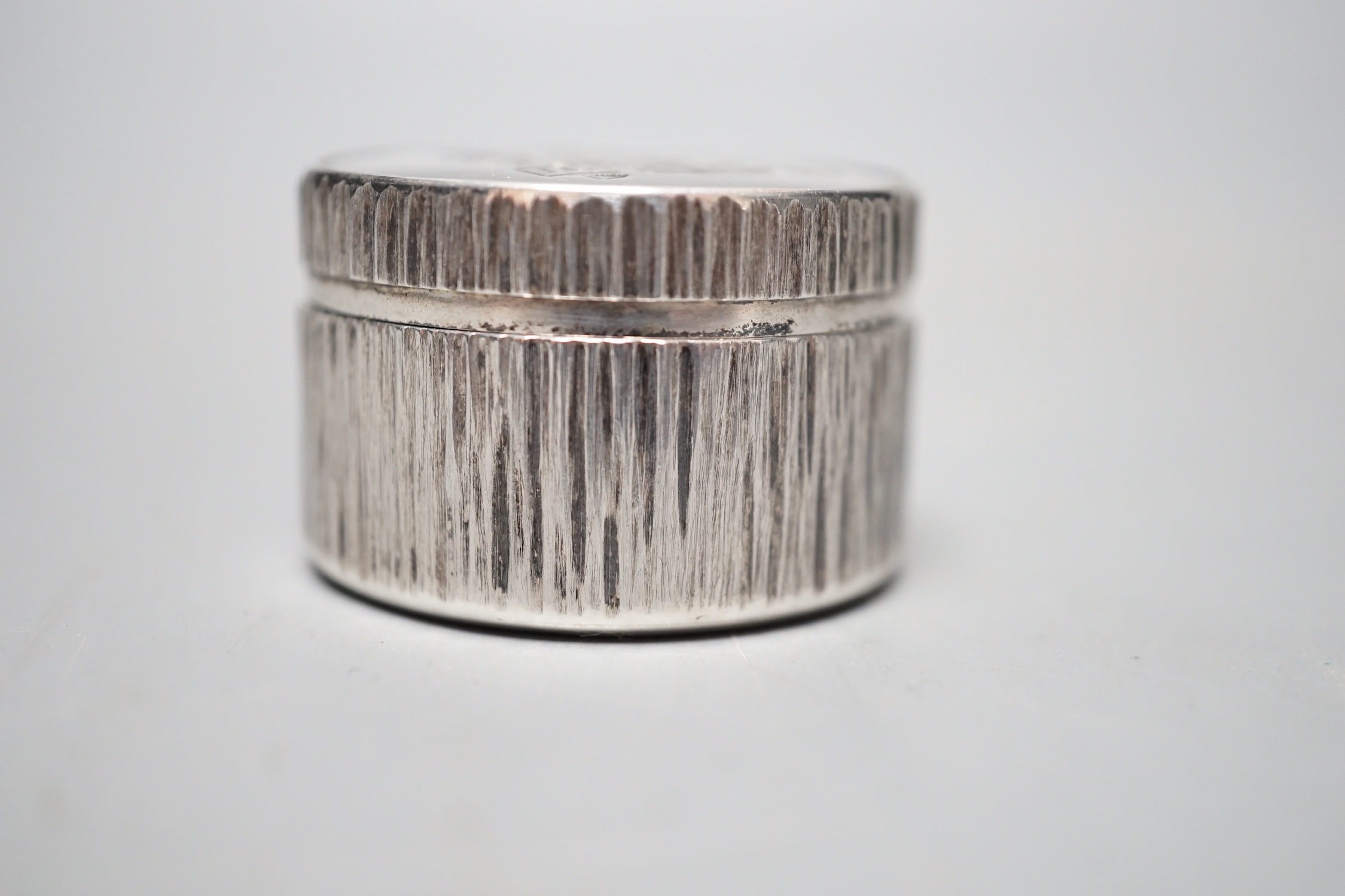 Adrian Gerald Benney- A modern textured silver pill box, engraved with the Prince of Wales feathers, London, 1997